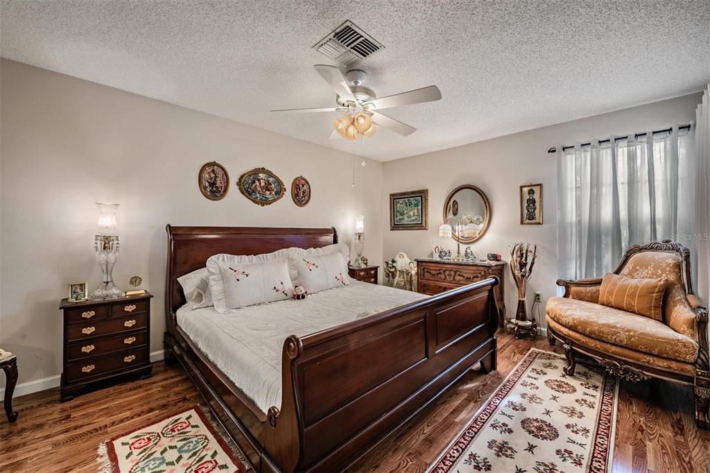 9302 Trowbridge Court New Port Richey, FL 34655 - Photo 22 of 41 a bedroom with a bed and a couch