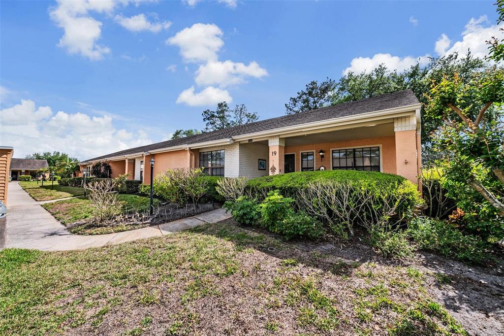 9302 Trowbridge Court New Port Richey, FL 34655 - Photo 3 of 41 a front view of a house with garden