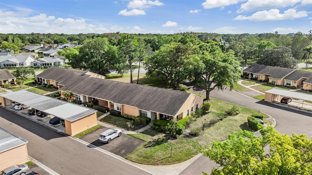 9302 Trowbridge Court New Port Richey, FL 34655 - Photo 32 of 41 an aerial view of a house with a garden and lake view