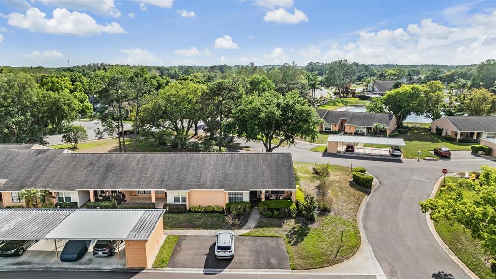 9302 Trowbridge Court New Port Richey, FL 34655 - Photo 33 of 41 an aerial view of a house with a garden and lake view