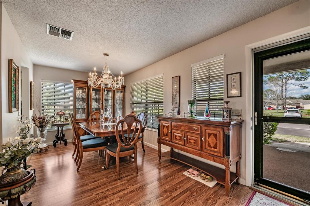 9302 Trowbridge Court New Port Richey, FL 34655 - Photo 5 of 41 a outdoor dining space with furniture window and wooden floor