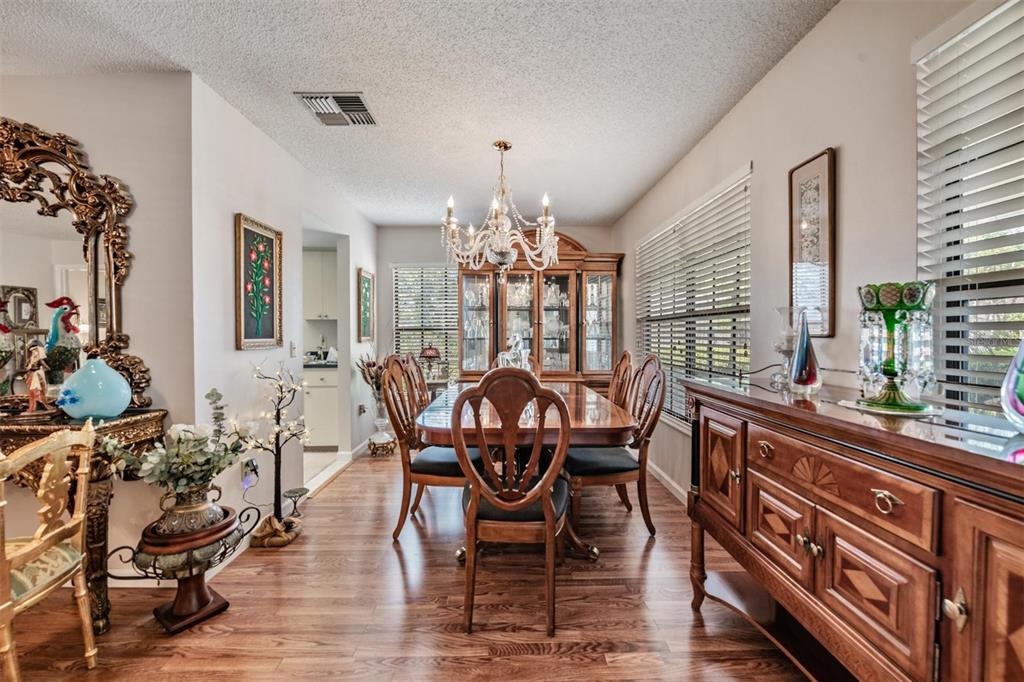 9302 Trowbridge Court New Port Richey, FL 34655 - Photo 6 of 41 a view of a dining room with furniture and chandelier
