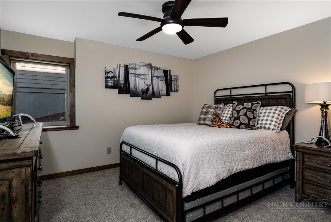 1161 Grandview Dr Extension Boone, NC 28607 - Photo 23 of 43 a bedroom with a bed and a flat tv screen