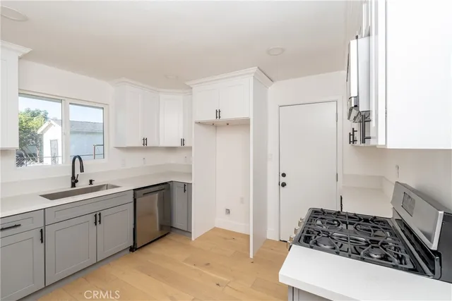 a kitchen with a sink stove and refrigerator