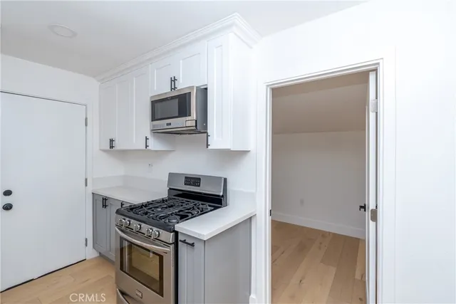 a kitchen with a stove and a microwave