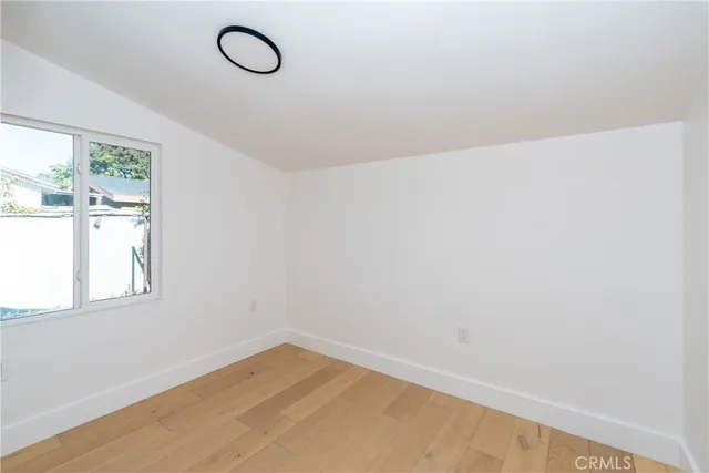 a view of white wall with a window