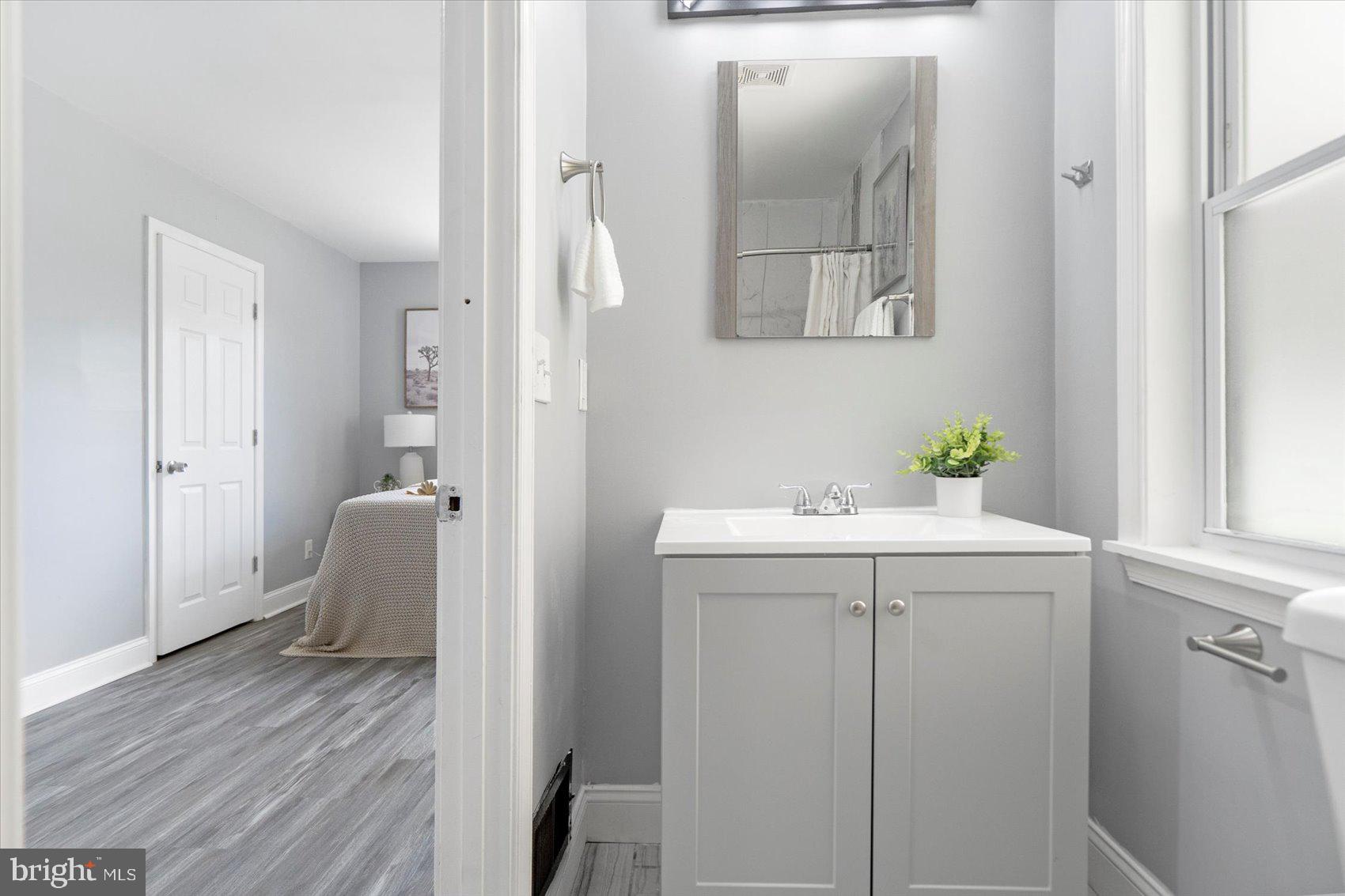 6628 Hartwait Street Baltimore, MD 21224 - Photo 11 of 31 a bathroom with a sink and a mirror