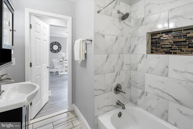 a bathroom with a bathtub and a sink