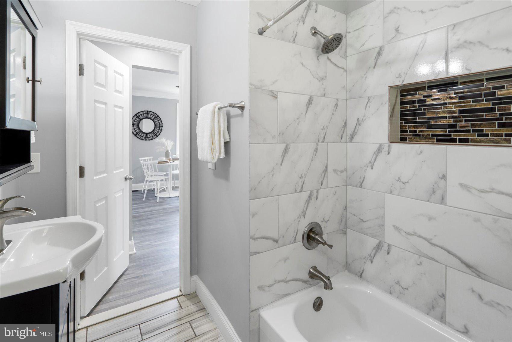 6628 Hartwait Street Baltimore, MD 21224 - Photo 13 of 31 a bathroom with a bathtub and a sink
