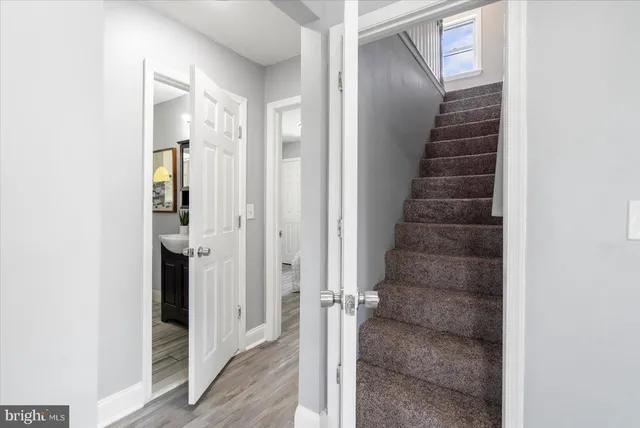 a view of a hallway with wooden floor and entryway