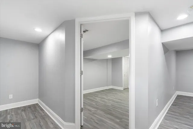 a view of hallway with wooden floor