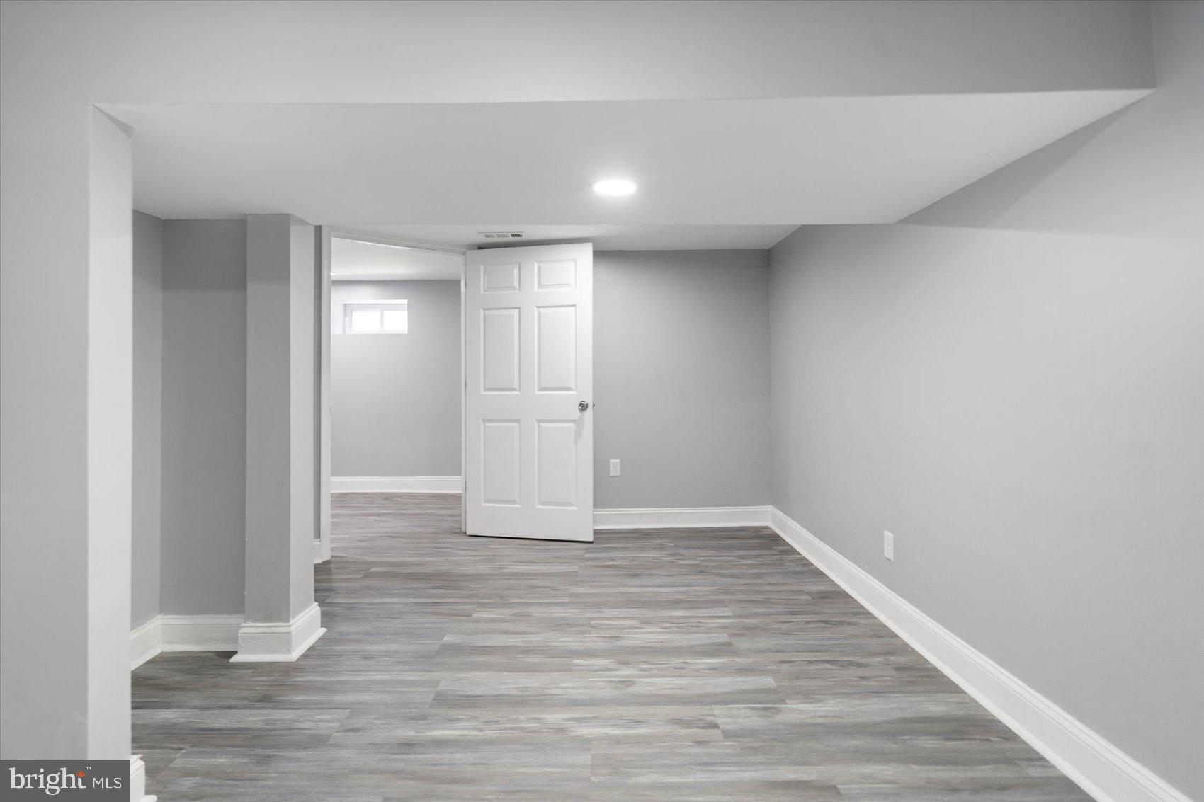 6628 Hartwait Street Baltimore, MD 21224 - Photo 22 of 31 a view of an empty room and wooden floor
