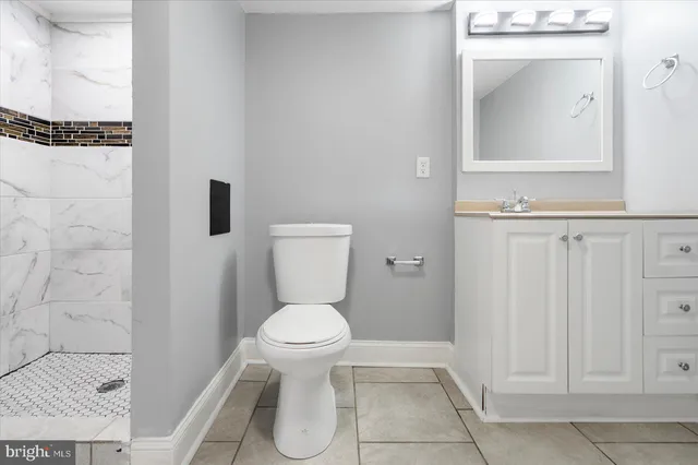 a bathroom with a toilet and a mirror