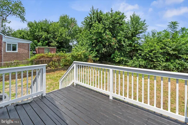 a view of balcony with wooden floor and fence