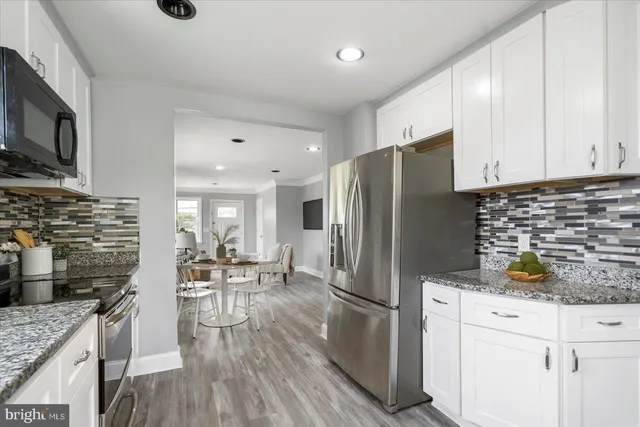a kitchen with stainless steel appliances a refrigerator stove microwave and cabinets