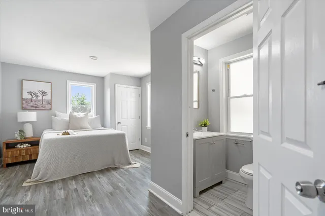 a living room with furniture and a window with wooden floor