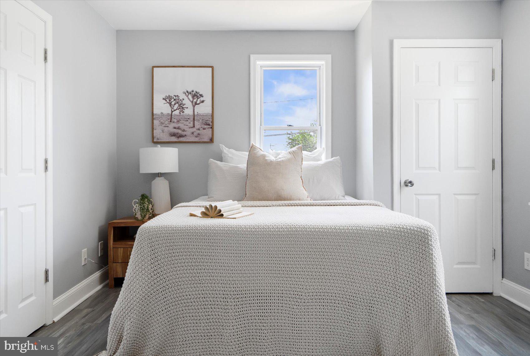 6628 Hartwait Street Baltimore, MD 21224 - Photo 10 of 31 a bedroom with a bed and painting on the wall