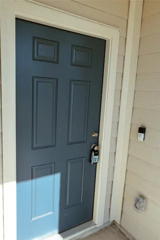 an empty room with a window and a ceiling fan