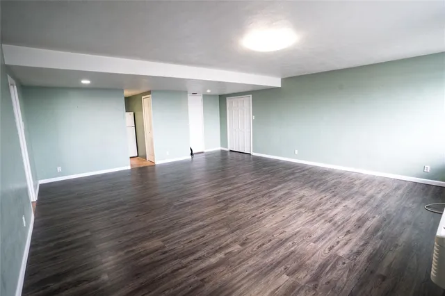 a view of wooden floor and cabinet in a room