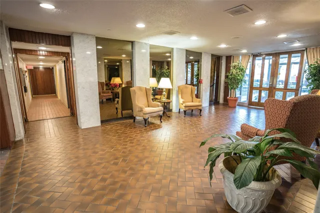 a lobby with furniture and floor to ceiling window