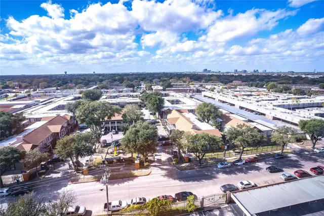 a front view of a house with garden and trees
