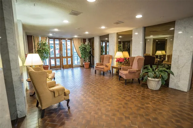 a lobby with furniture and floor to ceiling window