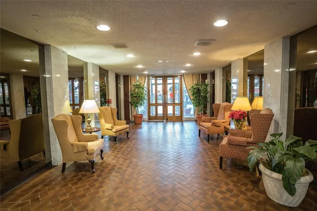 a living room with furniture and floor to ceiling window