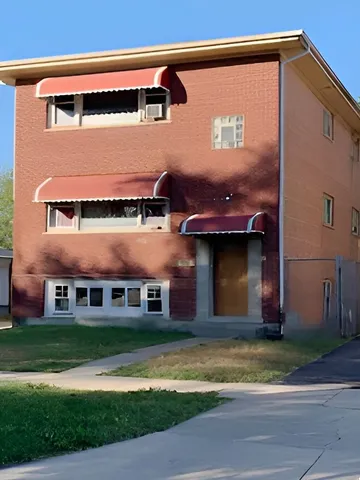 a view of a building with a yard