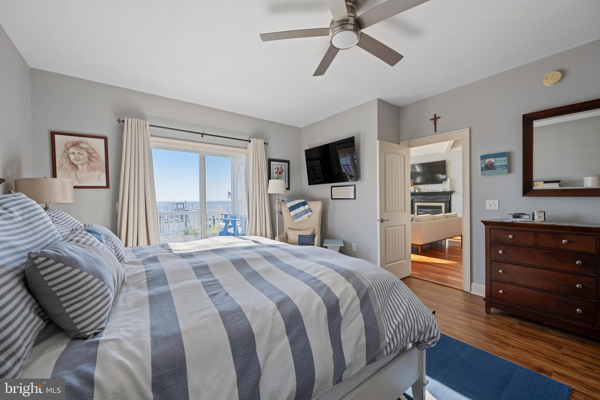 10482 Cassandra Drive Chance, MD 21821 - Photo 60 of 91 a bedroom with a bed a dresser and flat screen tv