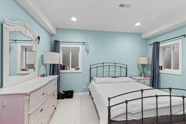 a bedroom with a bed and a large window