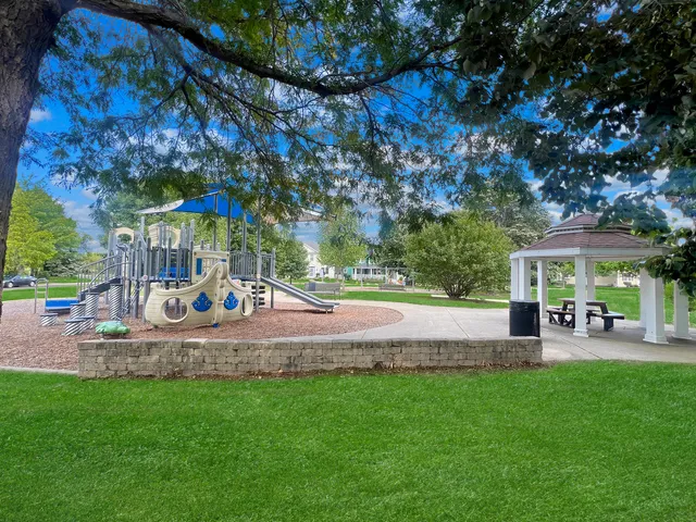 a view of a house with backyard sitting area and garden