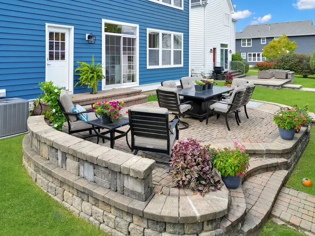 a view of a house with backyard sitting area and garden
