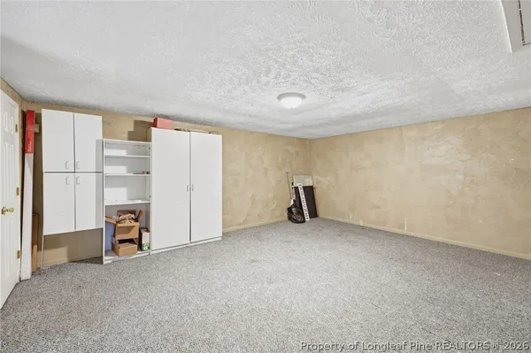 a view of an empty room with a fireplace