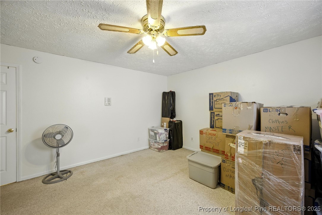223 Broadwell Road St. Pauls, NC 28384 - Photo 13 of 28 a room with a couch and a chandelier