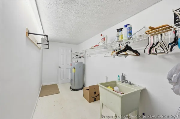 a view of storage and utility room with two washing machine