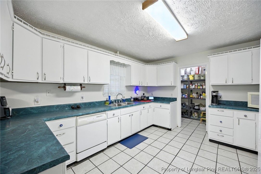 223 Broadwell Road St. Pauls, NC 28384 - Photo 15 of 28 a kitchen with a sink and cabinets
