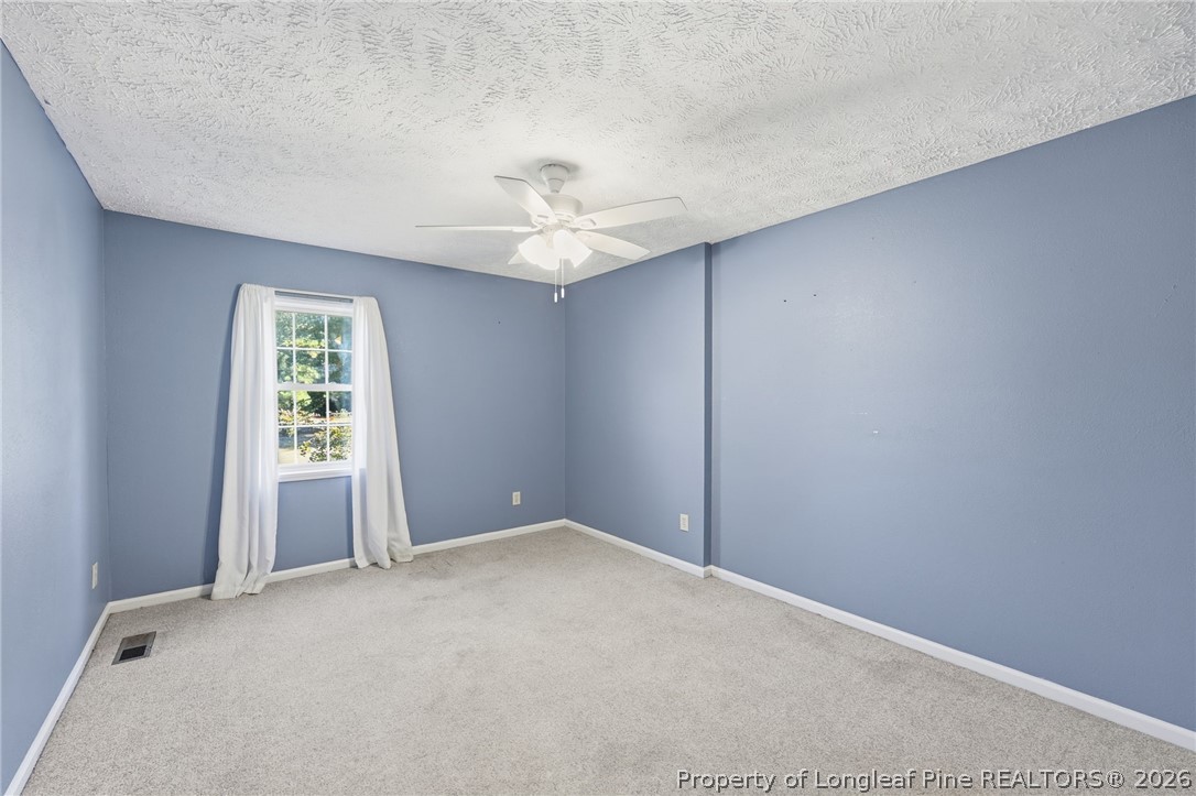 223 Broadwell Road St. Pauls, NC 28384 - Photo 15 of 28 an empty room with windows and fan