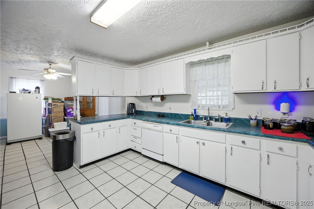 223 Broadwell Road St. Pauls, NC 28384 - Photo 17 of 28 a kitchen with granite countertop a sink and cabinets