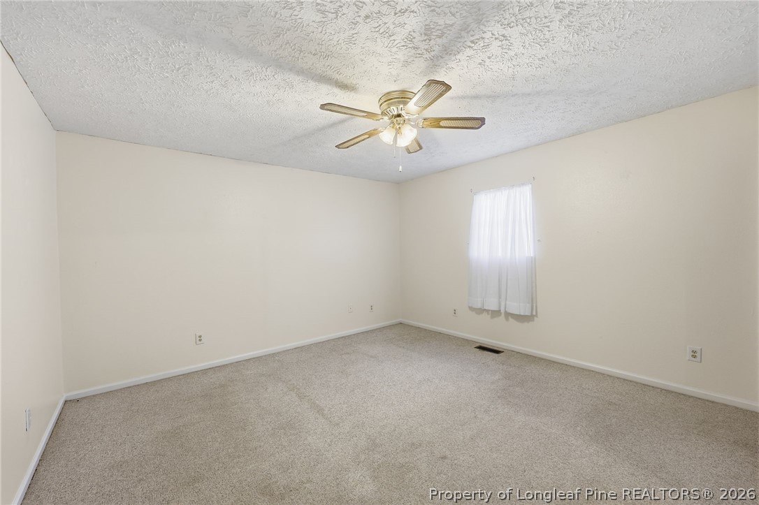 223 Broadwell Road St. Pauls, NC 28384 - Photo 18 of 28 an empty room with a window and a fan