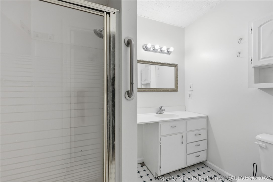 223 Broadwell Road St. Pauls, NC 28384 - Photo 20 of 28 a bathroom with a sink a toilet and shower