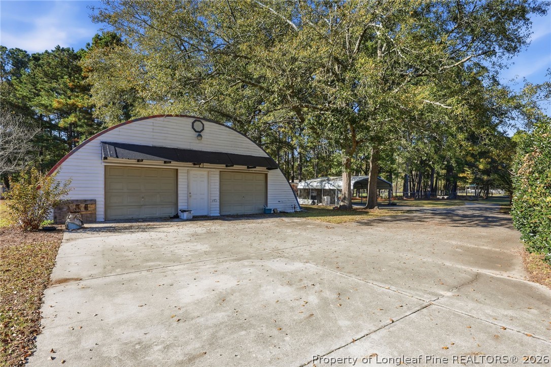 223 Broadwell Road St. Pauls, NC 28384 - Photo 23 of 28 a front view of a house with a yard and garage
