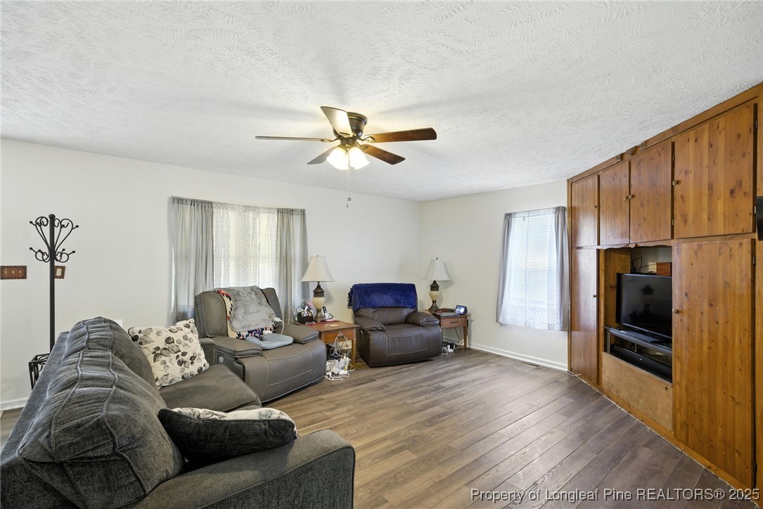 223 Broadwell Road St. Pauls, NC 28384 - Photo 23 of 28 a living room with furniture ceiling fan and a wooden floor
