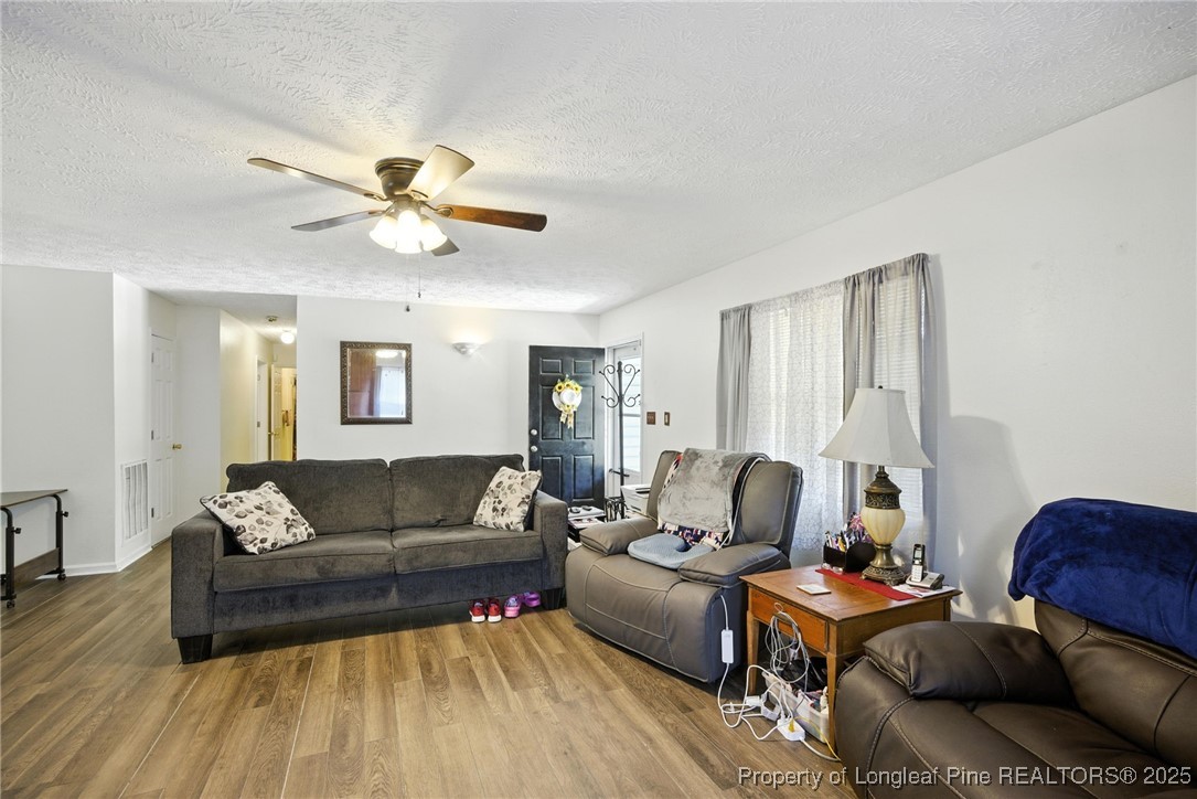 223 Broadwell Road St. Pauls, NC 28384 - Photo 24 of 28 a living room with furniture and a wooden floor