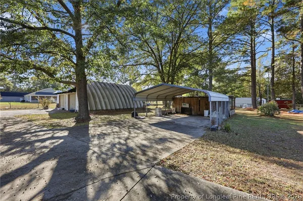 a view of a yard with a house and a tree