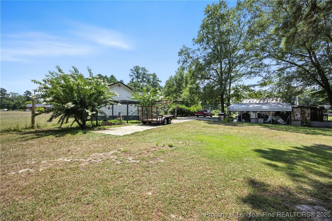223 Broadwell Road St. Pauls, NC 28384 - Photo 3 of 28 a swimming pool with outdoor seating and yard