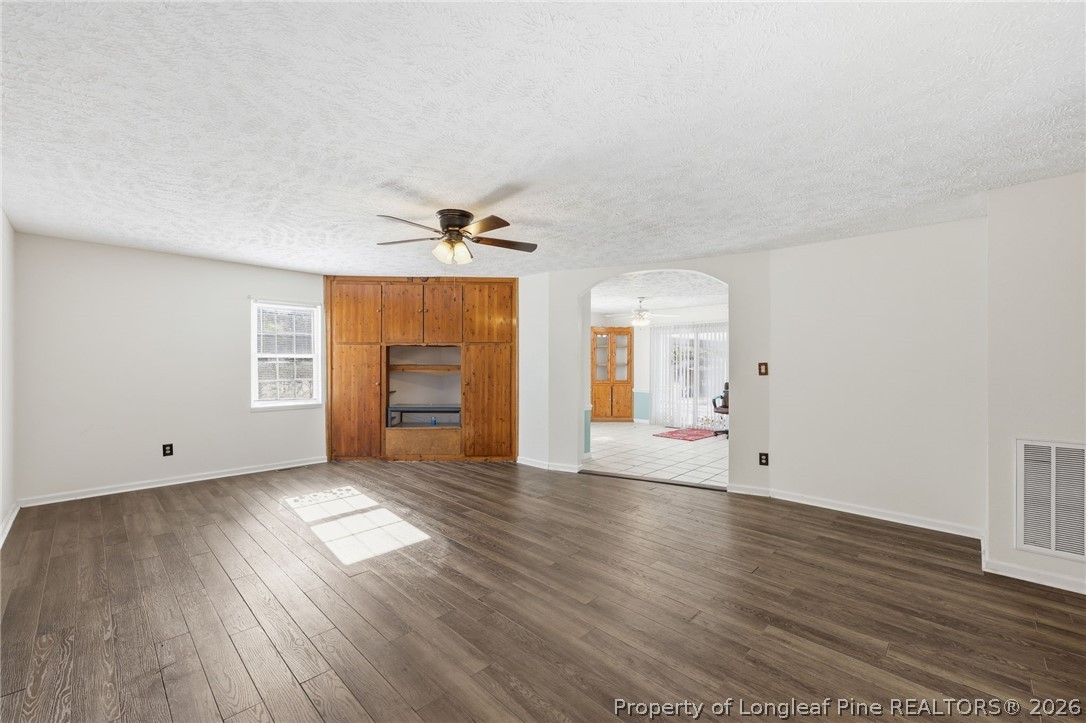 223 Broadwell Road St. Pauls, NC 28384 - Photo 4 of 28 an empty room with wooden floor and windows