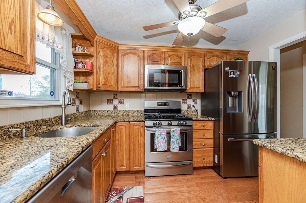 2 Lorenzo Road Lawrence, MA 01843 - Photo 16 of 42 a kitchen with stainless steel appliances granite countertop a refrigerator a stove and a sink