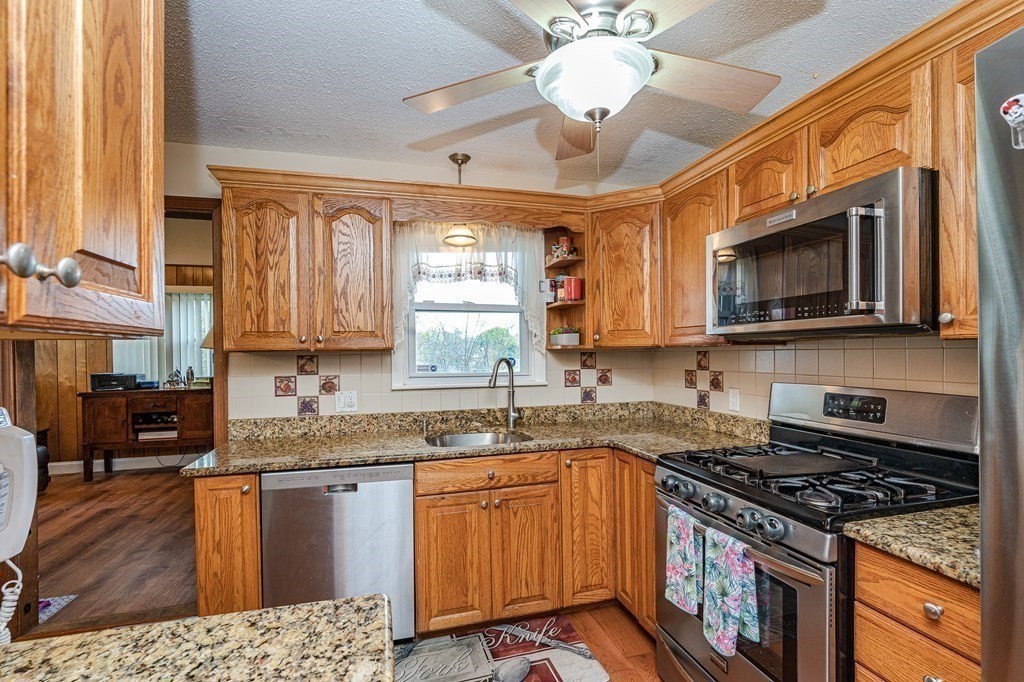 2 Lorenzo Road Lawrence, MA 01843 - Photo 17 of 42 a kitchen with stainless steel appliances granite countertop a sink stove and microwave