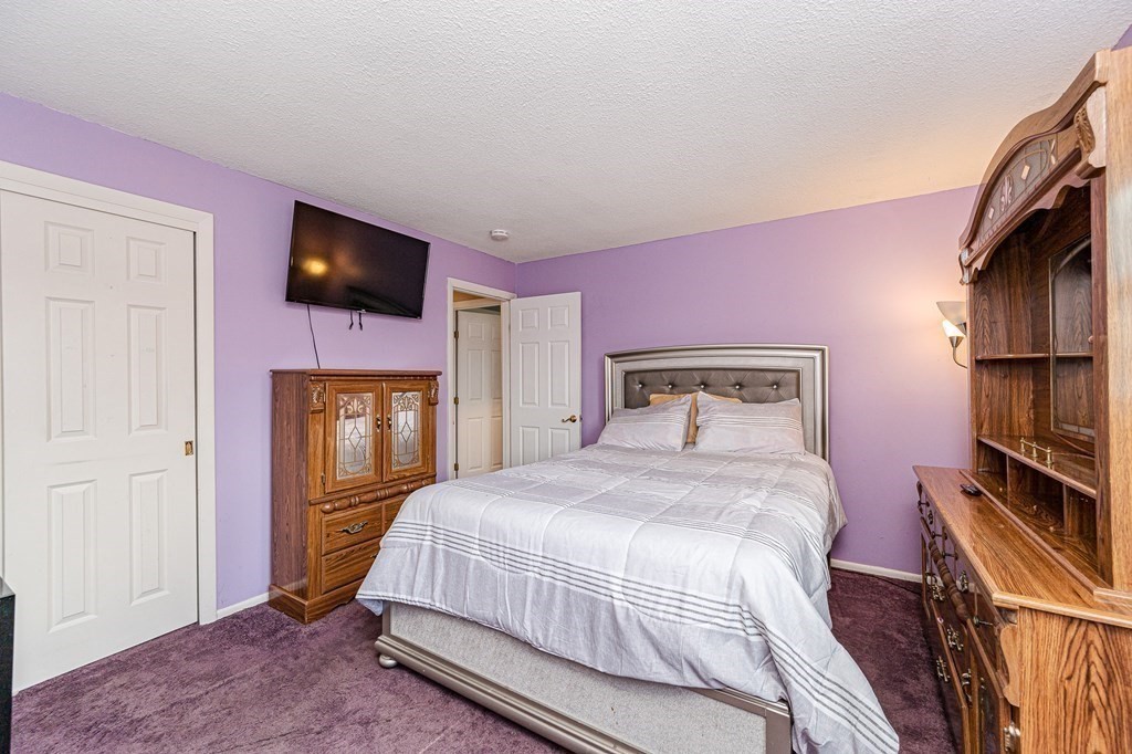 2 Lorenzo Road Lawrence, MA 01843 - Photo 22 of 42 a bedroom with a bed a flat screen tv and dresser
