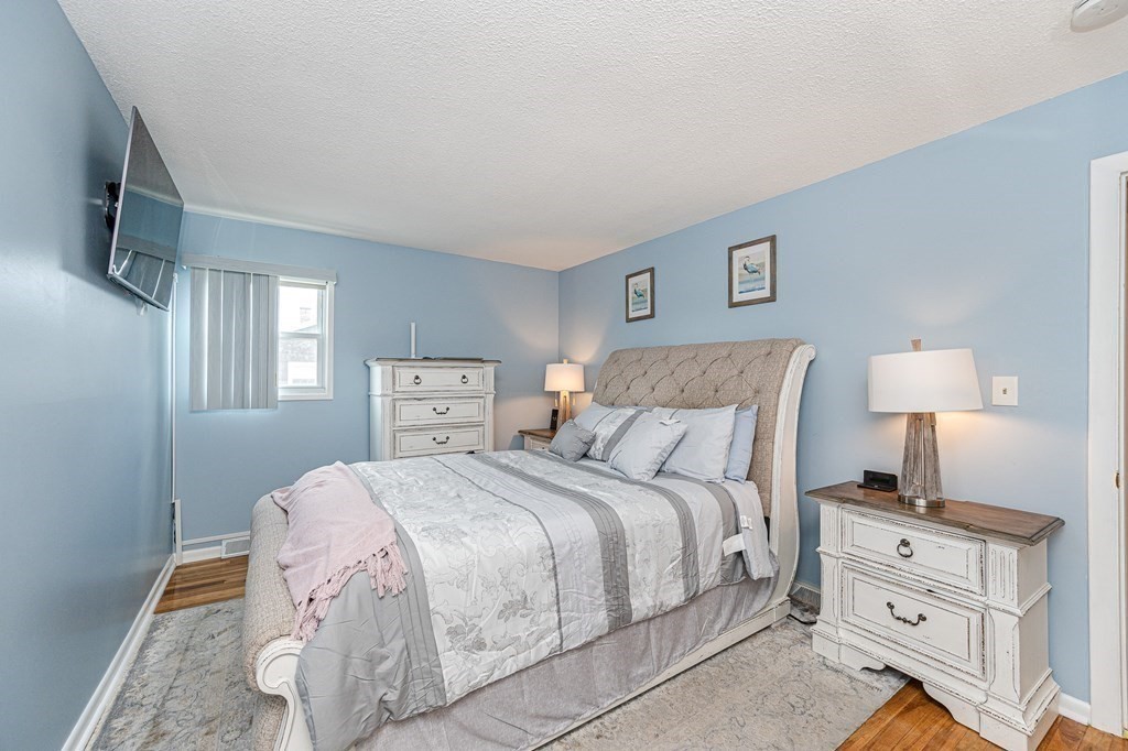 2 Lorenzo Road Lawrence, MA 01843 - Photo 24 of 42 a bedroom with a bed and a night stand